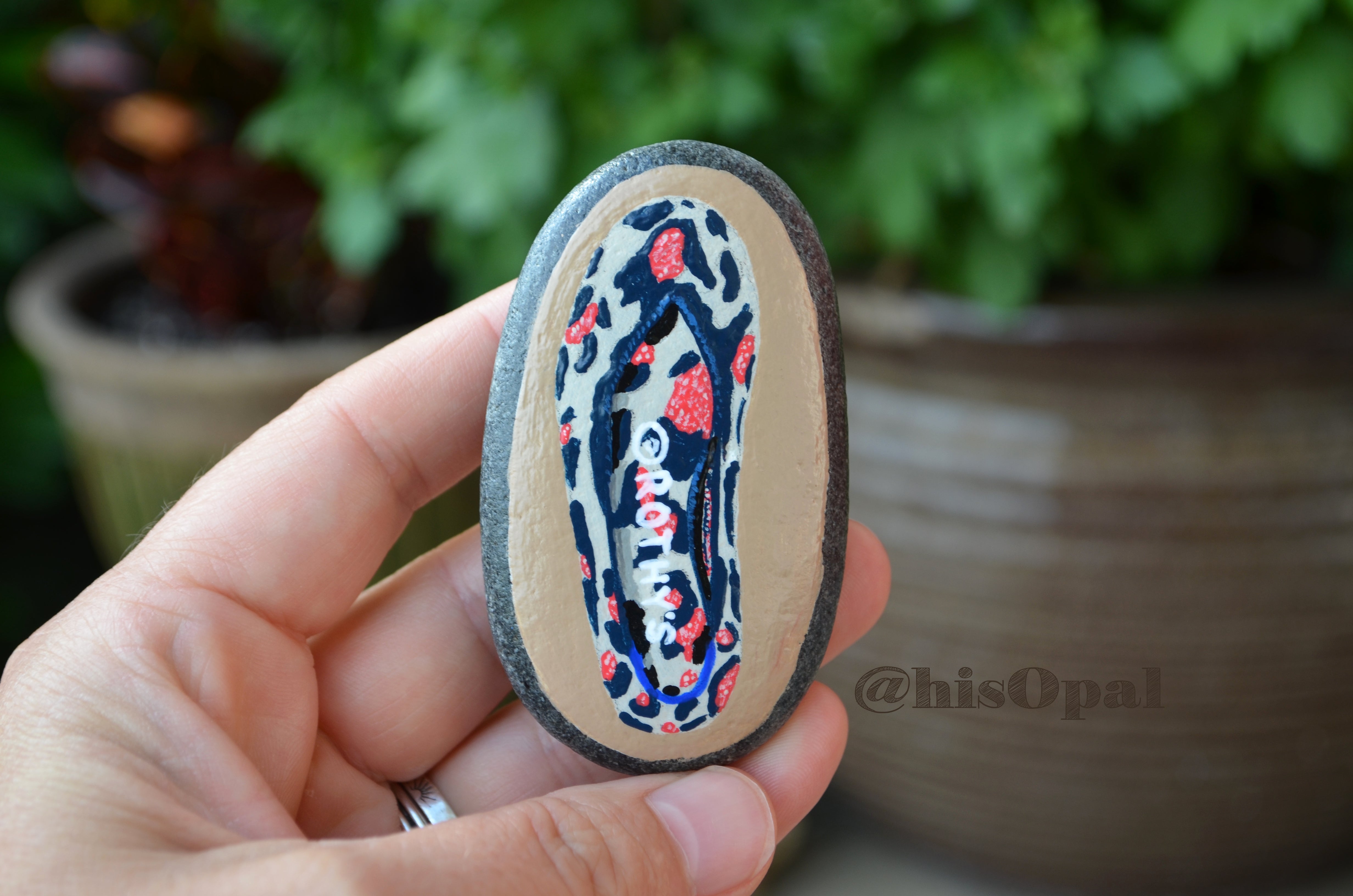 Red Sneaker Shoe Painted on A Small Stone is Painted With 